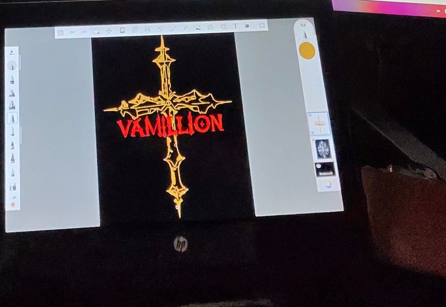 The VAMILLION gothic cross design being drawn on a tablet